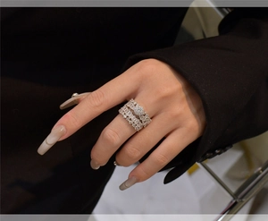 Close-up of S925 silver stacked snowflake rings with rectangular zircon on female finger