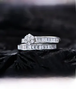 Macro view of micro-pave baguette-cut zircons on silver stacked ring set