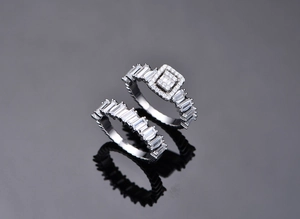 Macro shot of silver stacking rings with baguette-cut and round cubic zirconia stones