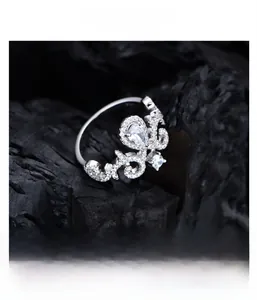 Macro detail of crown ring with pear-cut zircon and micro-pave setting in 925 silver