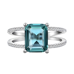 Emerald cut blue sapphire silver ring with split shank and micro pave accent stones