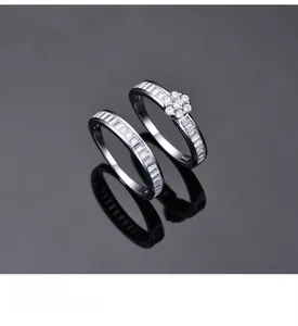 Detail of stacked S925 silver rings with square zircon stones and platinum plating finish
