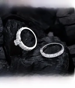 Macro shot of S925 silver half-eternity ring with micro-paved diamonds on charcoal