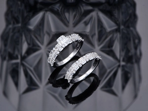 Close-up of S925 sterling silver rings with rectangle zircons on a dark diamond background