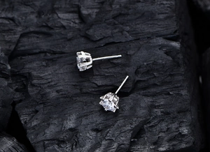 Detailed 45-degree angle view of classic six-prong 925 silver stud earrings with crystals