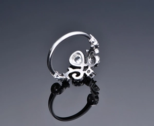 Macro shot of silver crown ring with teardrop gemstone and micro-pave cubic zirconia