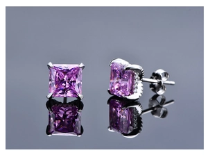 Macro detail of princess cut pink high carbon diamond studs with side pavé setting