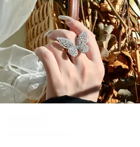 Detailed view of sterling silver butterfly ring with sparkling cubic zirconia on finger