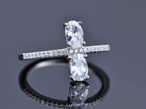 Macro shot of 925 silver ring featuring two oval-cut crystals and pavé side stones