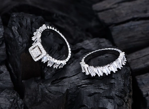Detailed view of two stacked S925 silver rings with square cut cubic zirconia stones