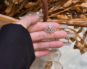 Macro shot of silver crown ring with water drop stone and pavé cubic zirconia