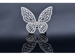 Macro shot of silver butterfly ring with intricate cutout details and pavé set zircons