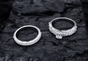 Detail shot of S925 silver rings with emerald cut cubic zirconia on a black coal background