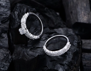 Macro shot of S925 sterling silver rectangular checkered rings on dark background