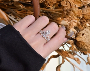 Detail of silver crown ring with pave micro-diamonds and teardrop-cut center gemstone