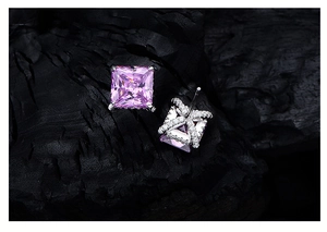 Macro shot of 925 silver square pink diamond earrings with cross accent detail