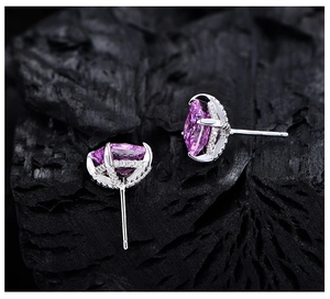 Detailed macro view of rose red marquise cut earrings in 925 silver setting with micro pave