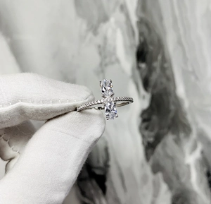 Macro shot of 925 silver ring featuring two oval-cut stones in a vertical prong setting