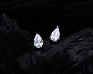 Macro shot of pear-cut sparkling studs featuring three-prong S925 silver settings