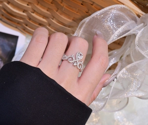 Detail shot of a micro-set 925 silver crown ring featuring a teardrop center stone