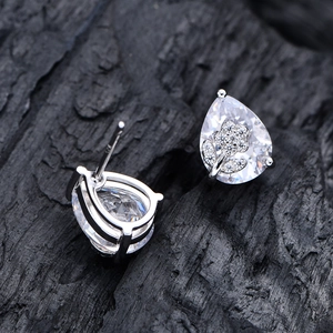 Pear-cut silver earrings featuring flower-patterned cubic zirconia and stud closures