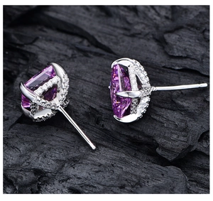 Detailed macro view of pear-cut purple gemstones set in S925 sterling silver earrings