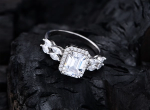 Macro detail of emerald cut white zircon ring with marquise leaf accents in 925 silver