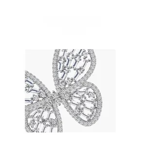 Macro shot of silver butterfly ring featuring baguette-cut and pavé-set zircon details