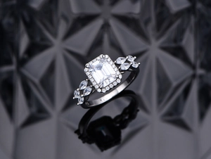Macro view of S925 silver ring with emerald cut white stone and marquise accents