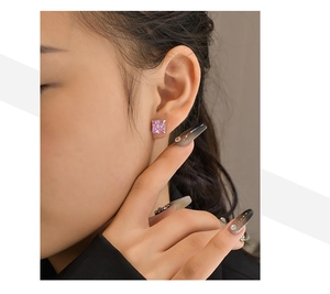 Macro side view of a model wearing square-cut pink high-carbon diamond silver earrings