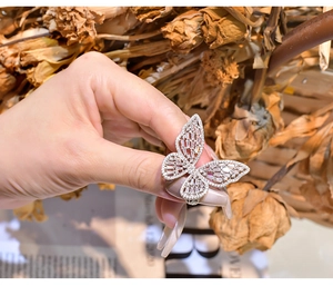 Detailed view of oversized butterfly ring with cubic zirconia on a model's hand