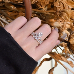 Vintage silver crown ring with micro-paved zircons and a pear-shaped center stone on hand