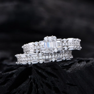 Luxurious emerald cut 925 silver ring set with micro-paved diamonds on black background