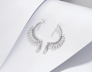 Detailed view of silver feather ear cuffs featuring marquise and pear cut crystals