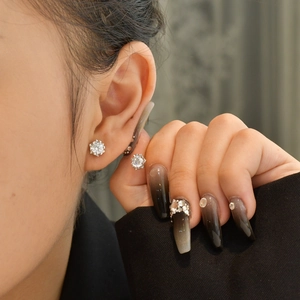 Classic 925 sterling silver snowflake stud earrings with 5mm cubic zirconia on ear