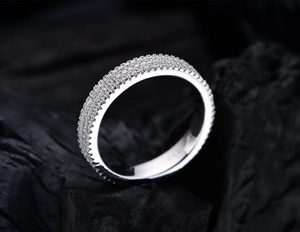 Macro shot of 925 sterling silver ring with three rows of pavé set round zircon stones