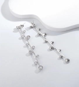 Macro shot of 925 sterling silver long tassel earrings with sparkling cubic zirconia charms