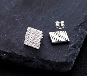 Macro view of square S925 silver stud earrings with micro-paved sparkling cubic zirconia