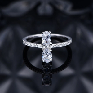 Elegant silver ring with 4x6mm oval cut gemstone and pavé setting on mirrored surface