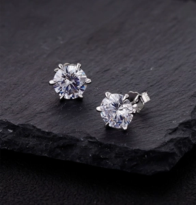 Macro view of 8mm six-prong solitaire stud earrings with S925 sterling silver stamp