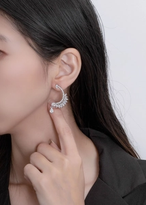 Close-up of elegant S925 silver feather earrings with sparkling marquise diamonds