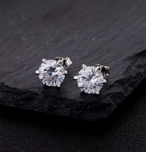 Macro detail of 8mm six-prong round-cut cubic zirconia stud earrings in 925 silver