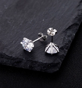 Detailed view of 8mm six-prong solitaire stud earrings with brilliant round-cut cubic zirconia