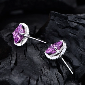 Rose pink 8x8mm square-cut gemstone earrings in 925 silver on black stone texture