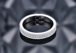 Macro view of triple-row eternity band with clear pave-set stones in 925 sterling silver