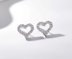 Close-up of heart-shaped S925 sterling silver stud earrings with cubic zirconia