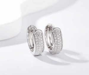 Macro shot of S925 sterling silver huggie earrings with triple row pave-set zircons