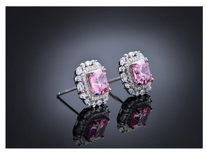 Macro shot of 925 silver halo earrings with pink Asscher cut stones and petal frame