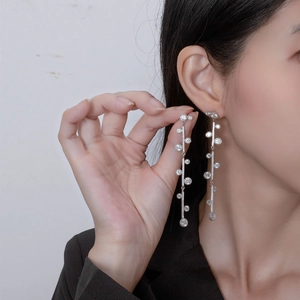 Elegant long tassel earrings with S925 silver and cubic zirconia crystals on a model