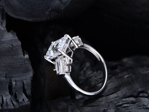Macro side view of emerald-cut high carbon diamond ring on charcoal background